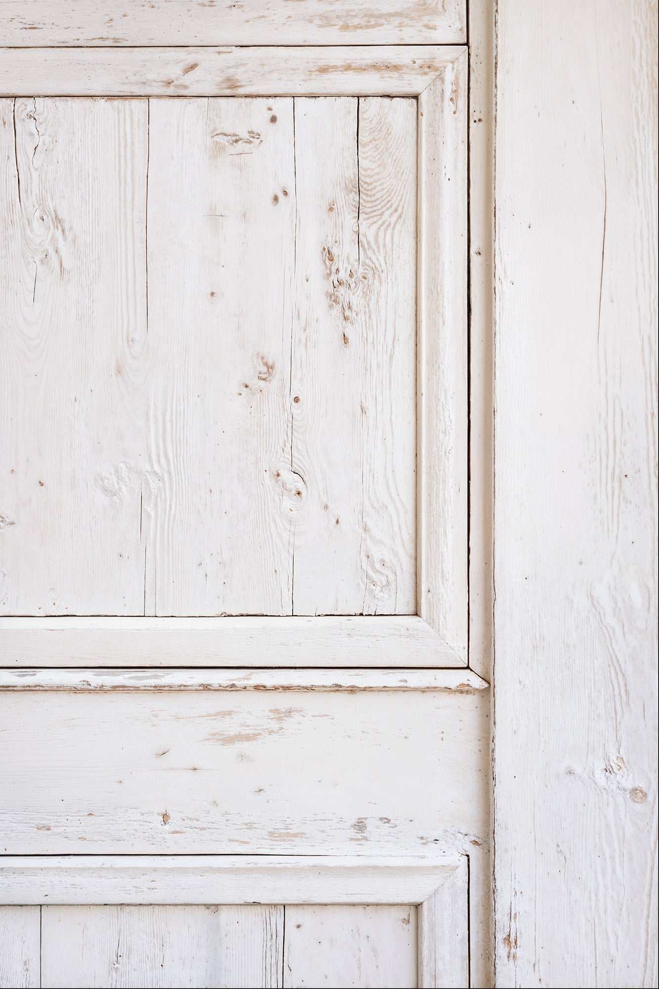 Classic white door with distressed paint and natural wood grain, ideal for rustic and vintage photography.