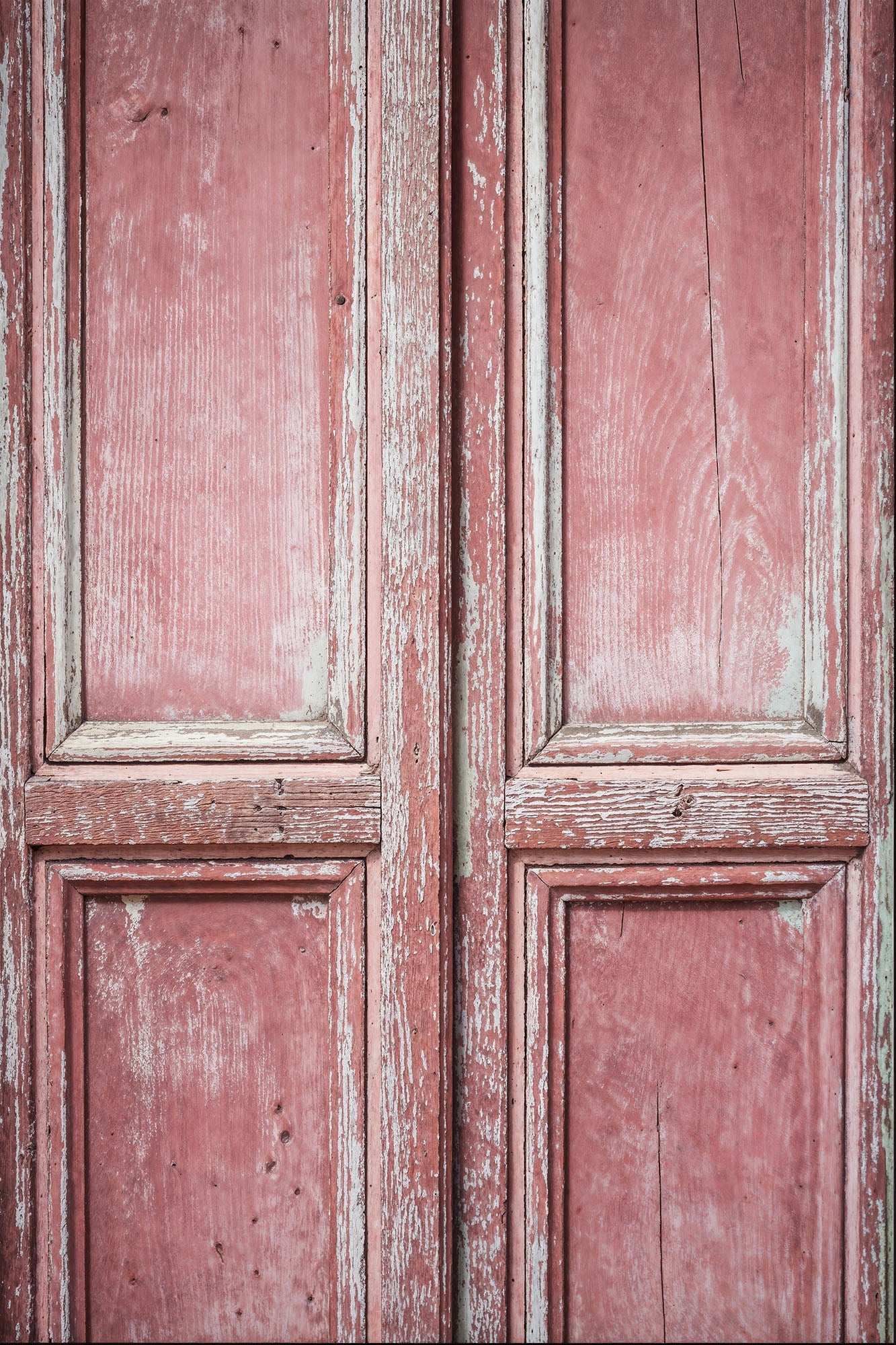 Faded blush vintage pink wood backdrop with distressed texture for photography.