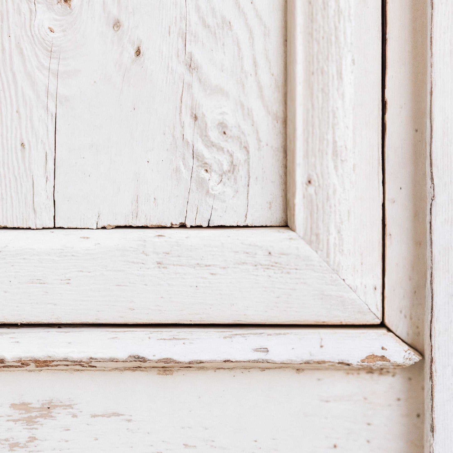 Classic white door with distressed paint and rustic wood grain.