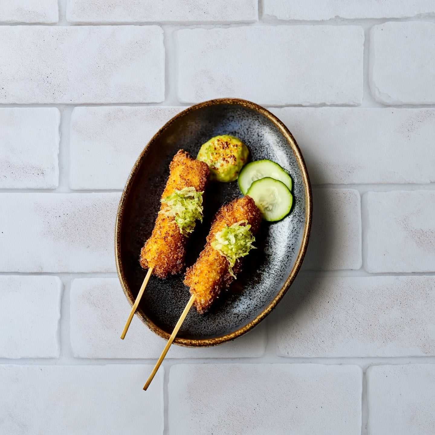 Whitewash brick backdrop with food platter showcasing minimalist textured design.