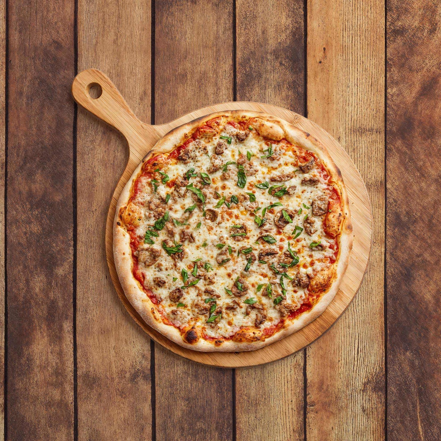 Aged Oak Planks with a rustic, weathered wood texture used as a backdrop for a pizza on a wooden board.