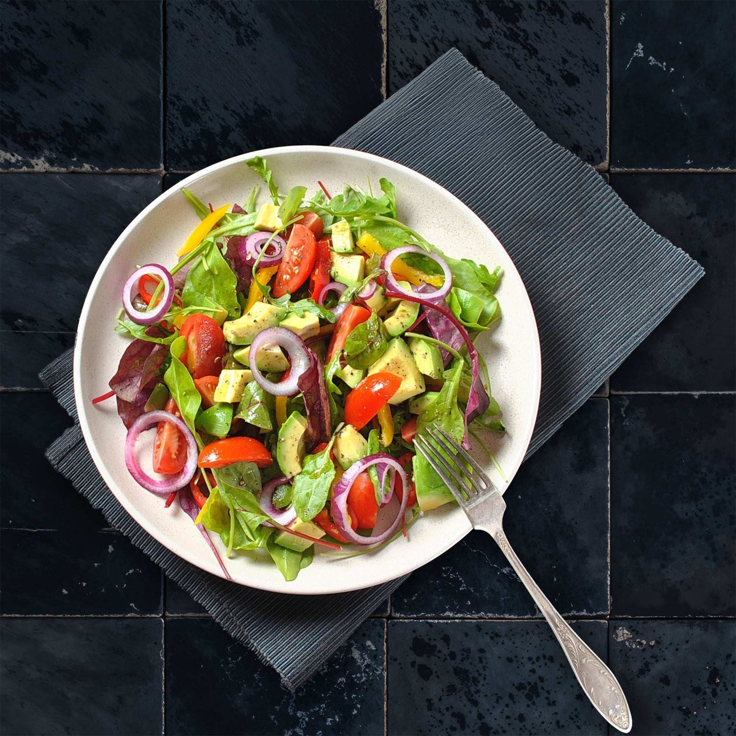 Black Mamba backdrop with deep slate tile pattern enhancing a salad's vibrant colors on a plate.