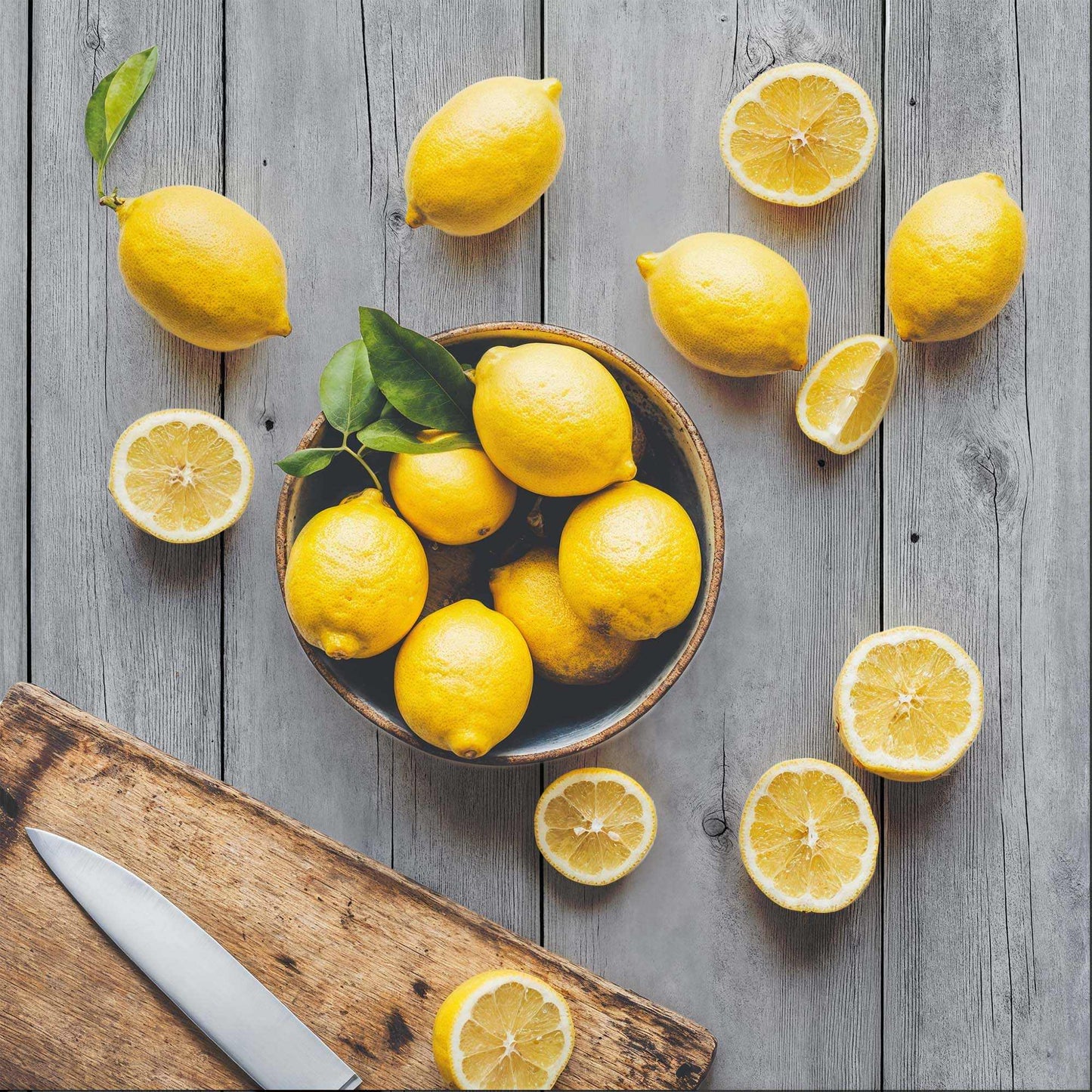 Driftwood Grey backdrop with lemons and wooden plank for minimalist photography.